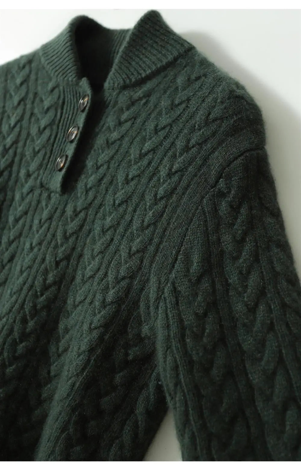 Olive green cable knit sweater with a stand collar, close view of the cable knit shoulder