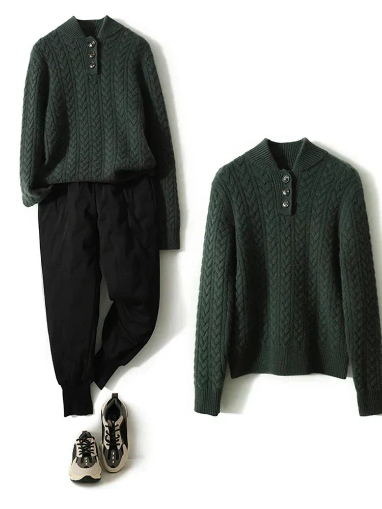 Olive green cable knit sweater with a stand collar, shown flat beside black pants