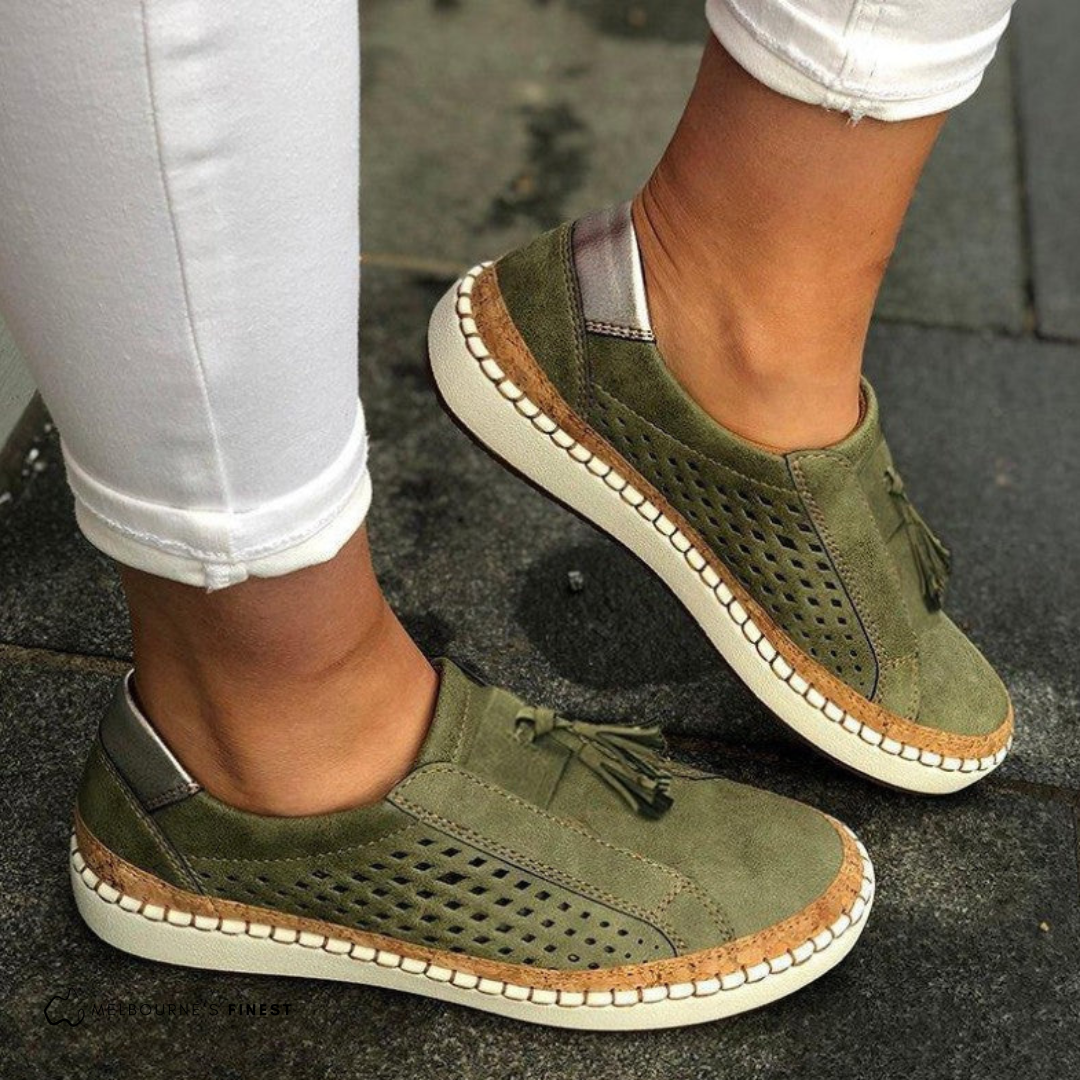 Olive green slip on sneakers with perforated panels and a tassel