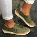 Olive green slip on sneakers with perforated panels and a tassel