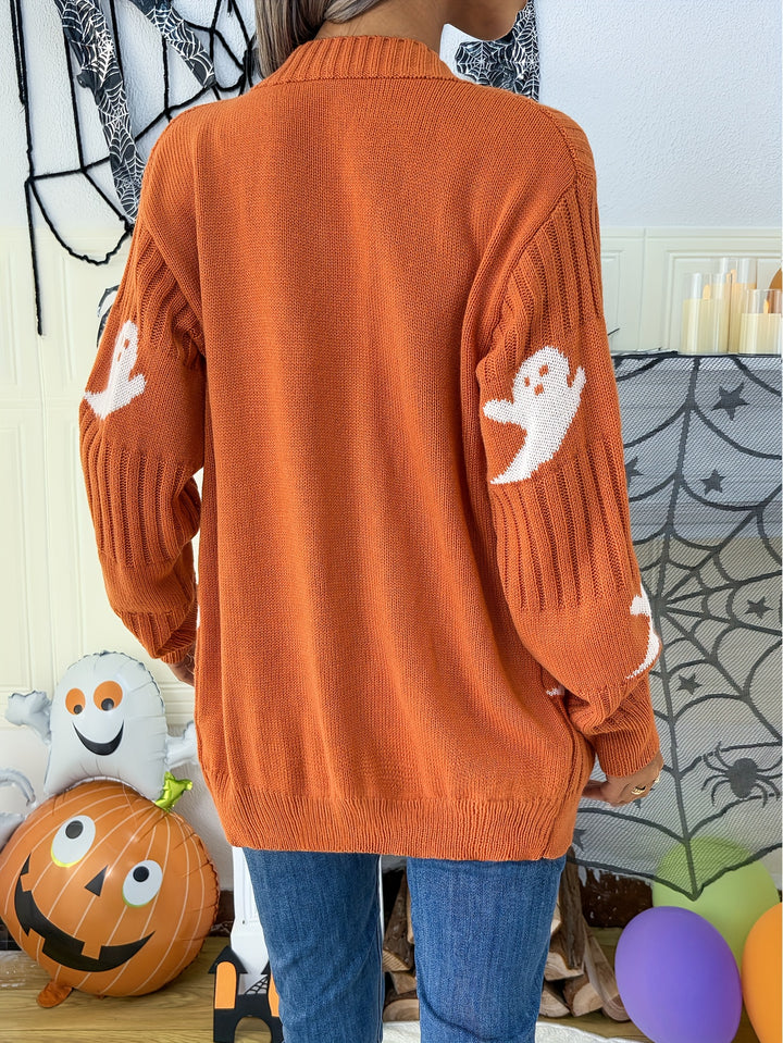 Back view of an orange ribbed cardigan with white ghost motifs on the sleeves