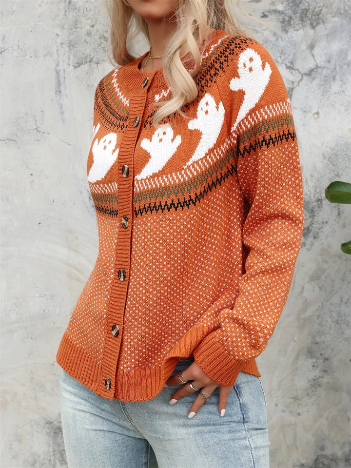Orange knit button cardigan with white ghost yoke pattern, worn with light jeans