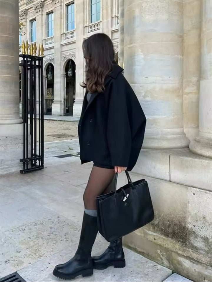 Black oversized cropped peacoat showing the dropped shoulder, side view