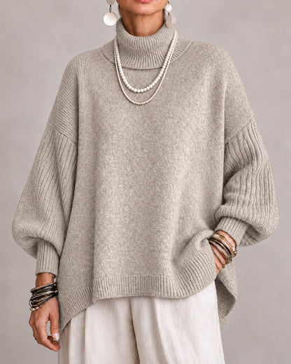 Beige oversized turtleneck sweater with ribbed balloon sleeves, front view