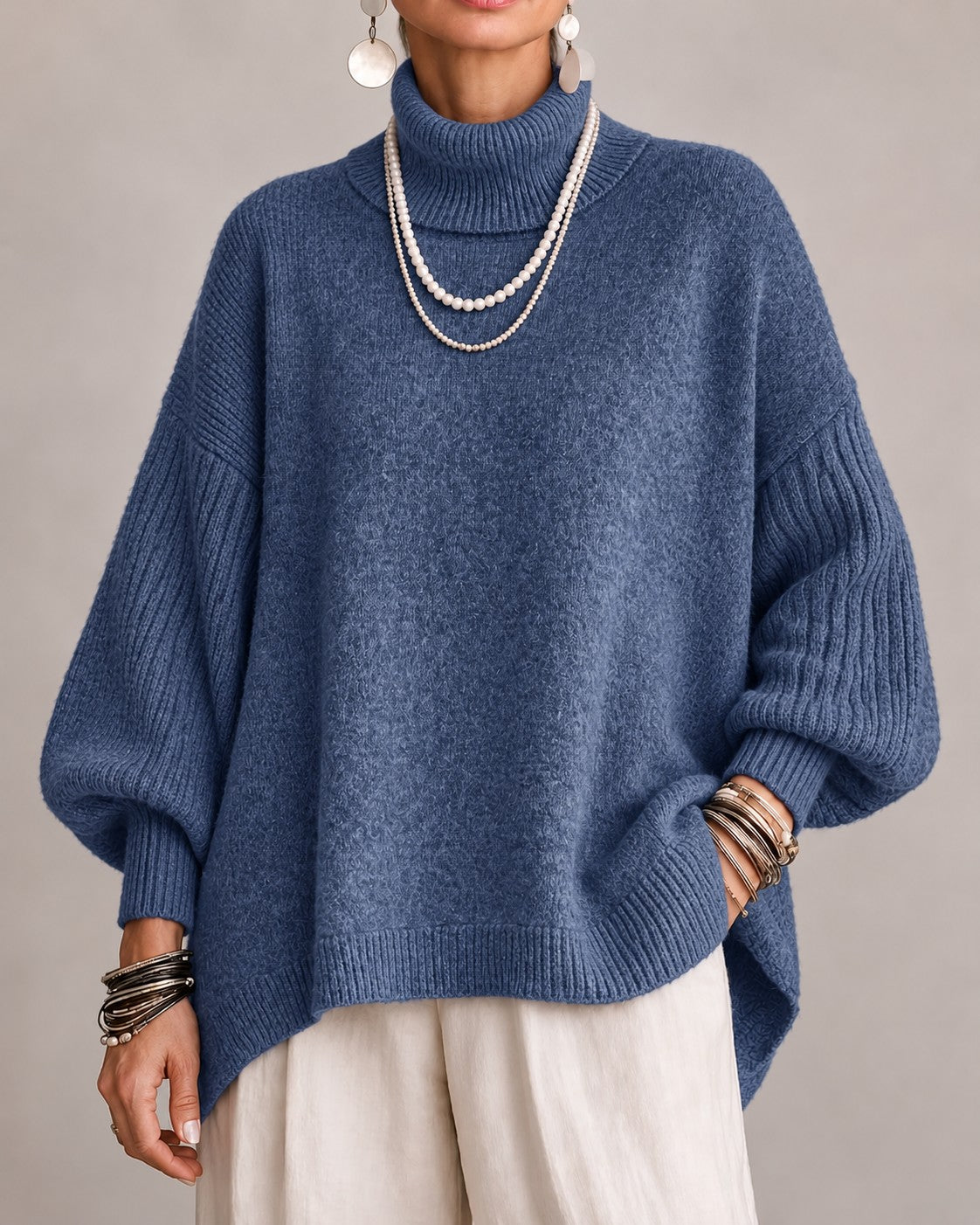Blue oversized turtleneck sweater with ribbed balloon sleeves, front view