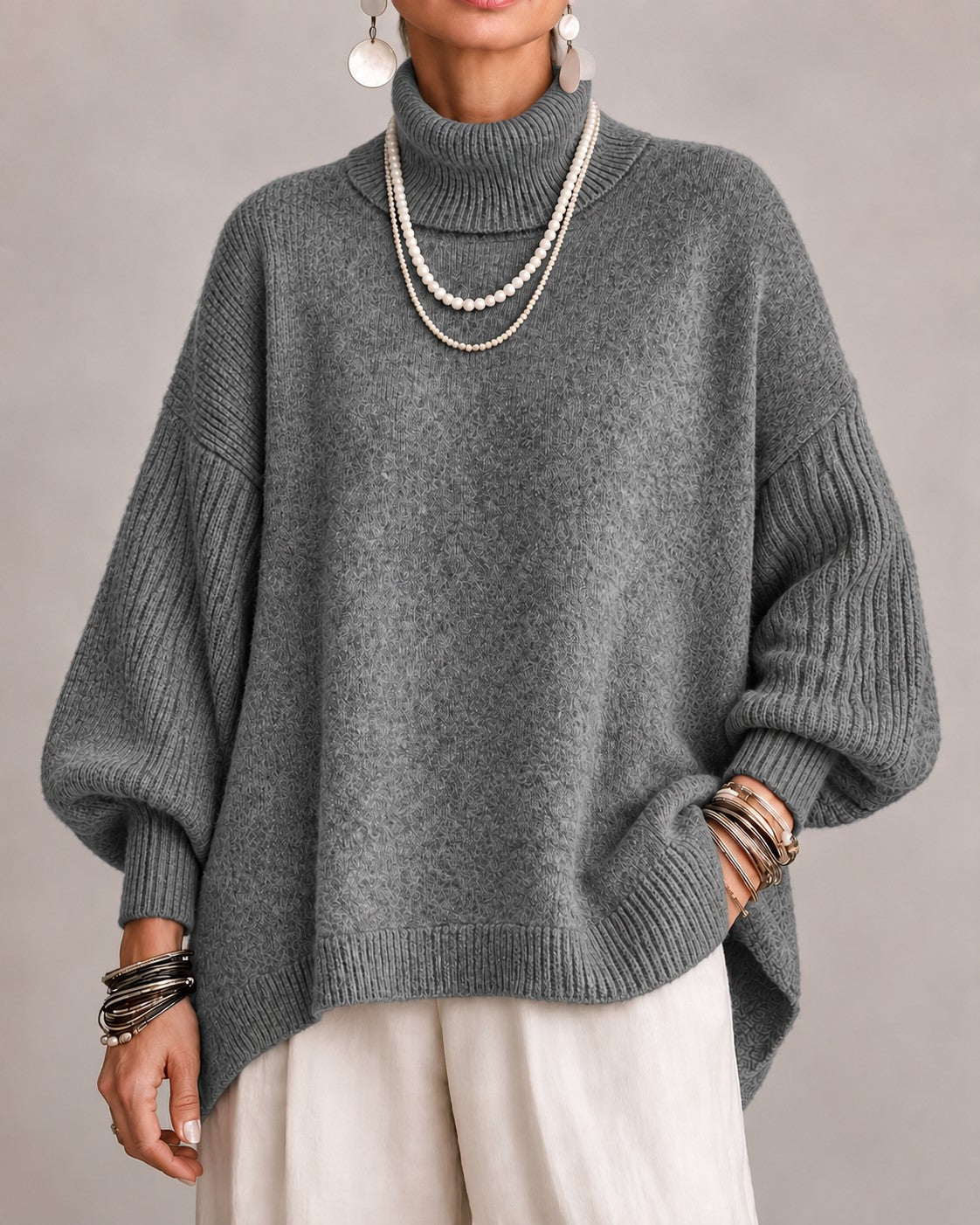 Gray oversized turtleneck sweater with ribbed balloon sleeves, front view