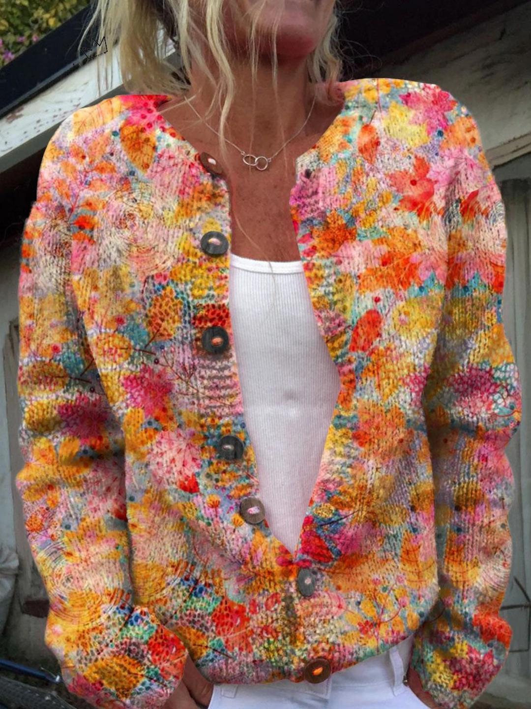 Knit cardigan in a painterly pink, orange and yellow flower print with wooden buttons