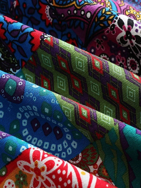 Folded lengths of the patchwork print fabric in several colourways