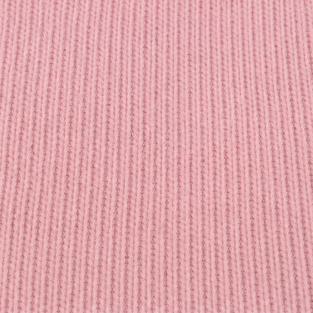 Close-up of the pink ribbed knit fabric of the cardigan