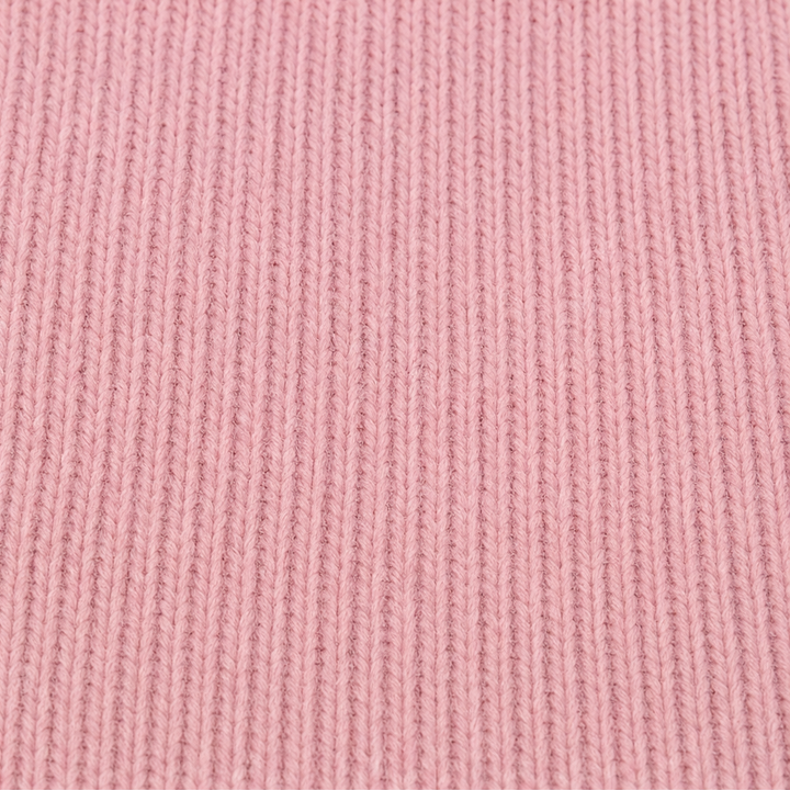 Close-up of the pink ribbed knit fabric of the cardigan