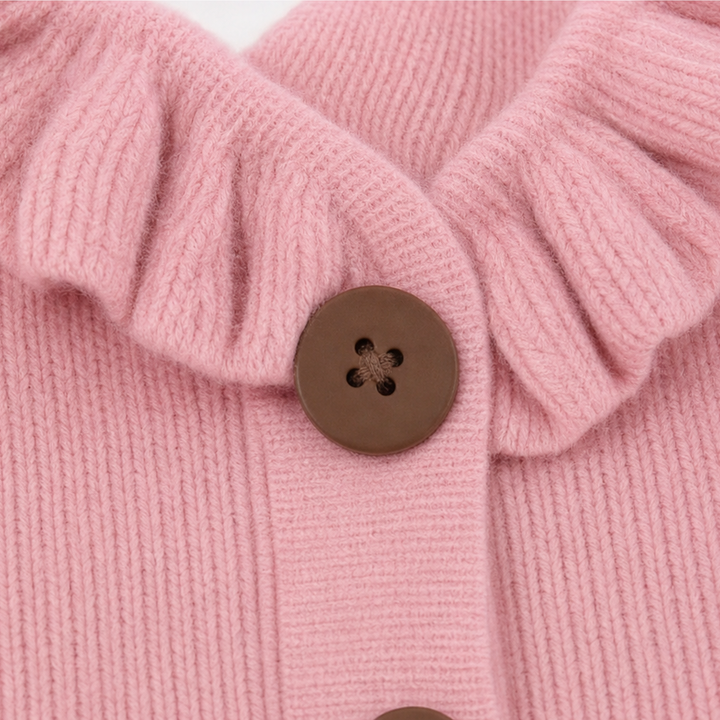 Close-up of the pink cardigan ruffle collar and brown button fastening