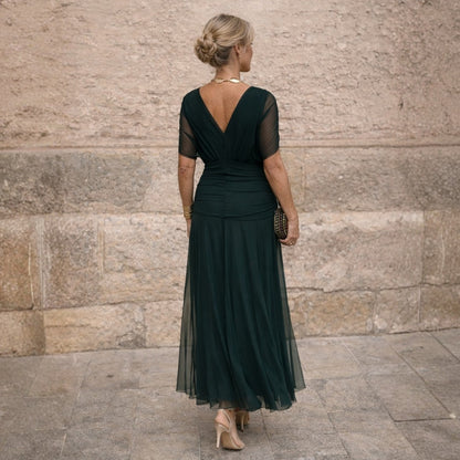 Back view of the dark green wrap dress showing the open V-back