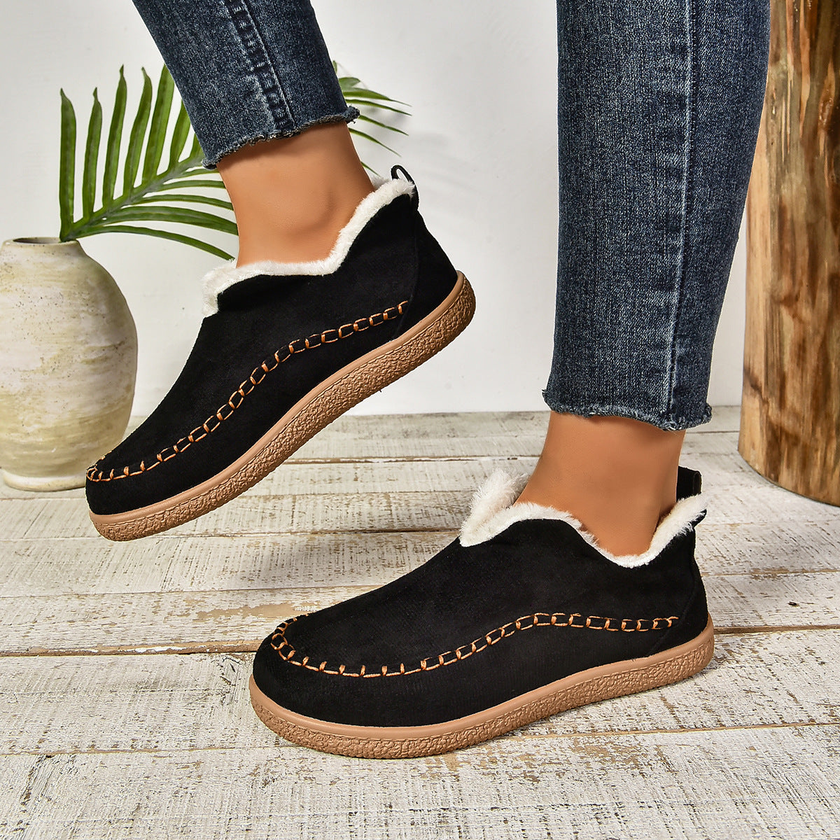 Black plush lined slip-on boots worn with cropped jeans