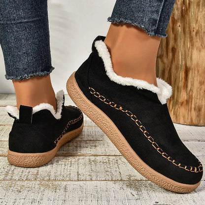 Black plush lined slip-on ankle boots with stitched moc toe, front view