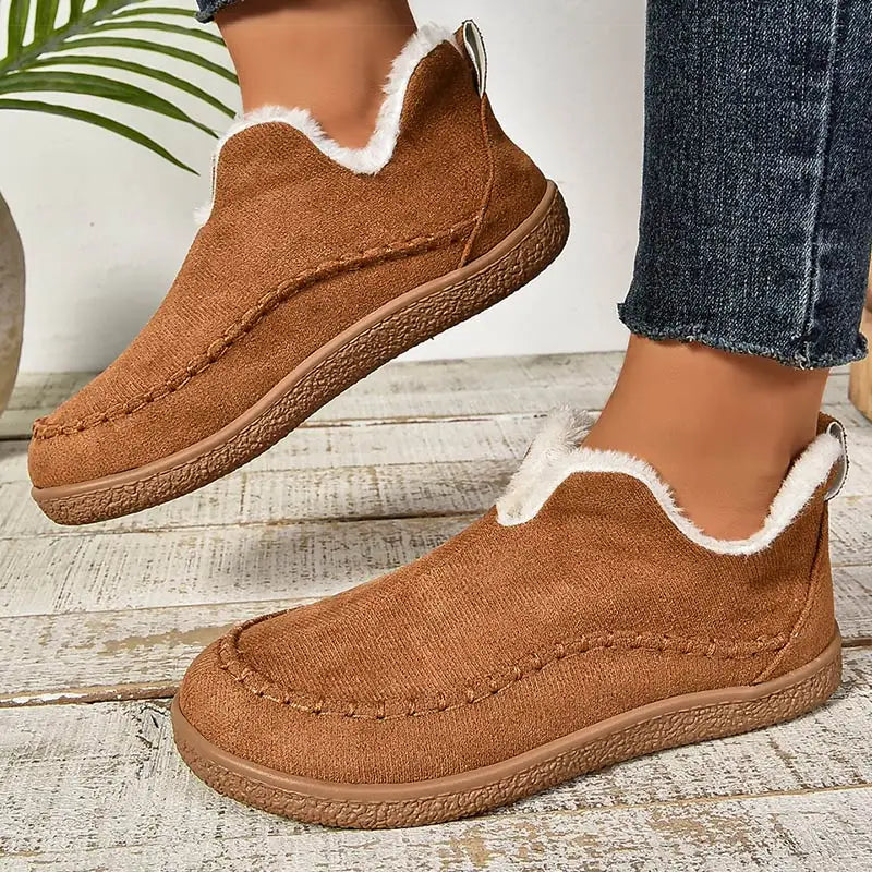 Brown plush lined slip-on boots worn with cropped jeans