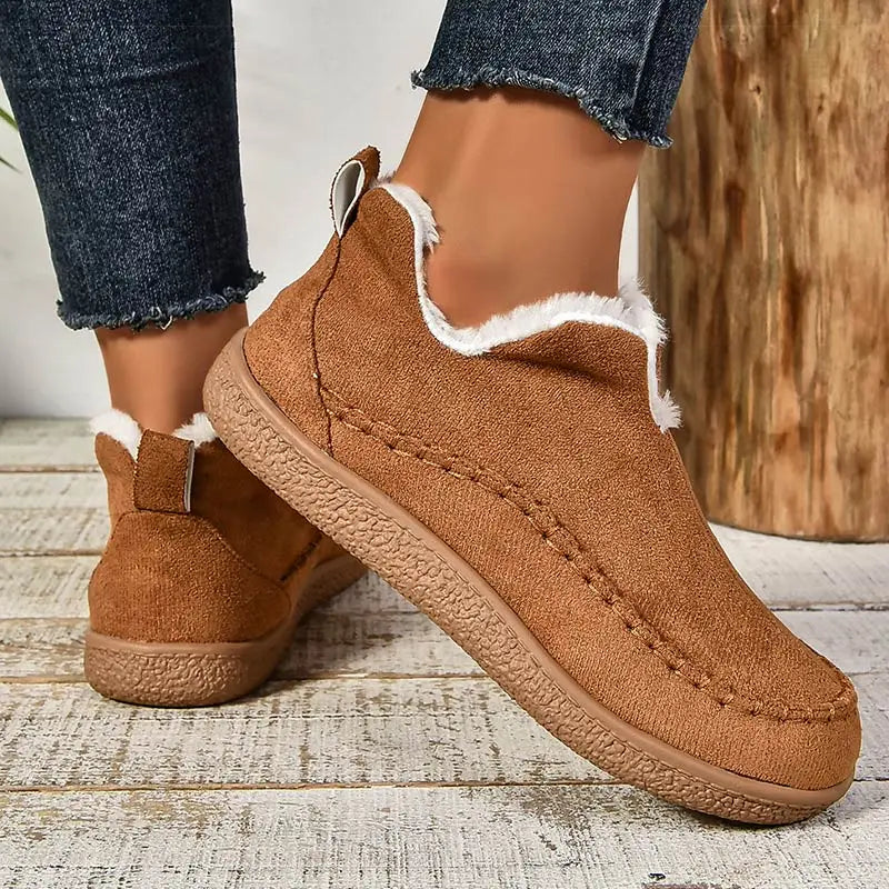 Brown plush lined slip-on ankle boots with stitched moc toe, front view