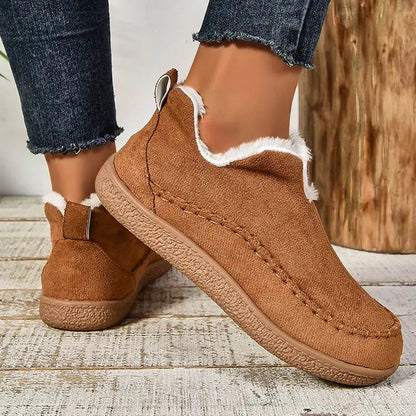 Brown plush lined slip-on ankle boots with stitched moc toe, front view