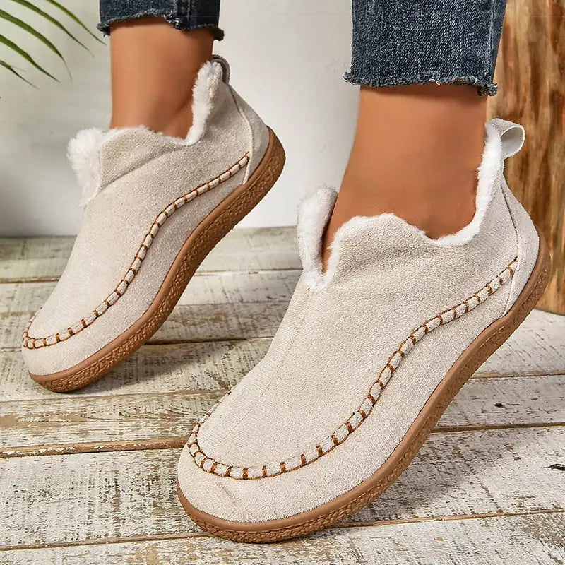 Oatmeal plush lined slip-on ankle boots with stitched moc toe, front view