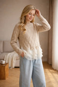 Oatmeal pointelle sweater with a layered ruffle hem and rosette trim