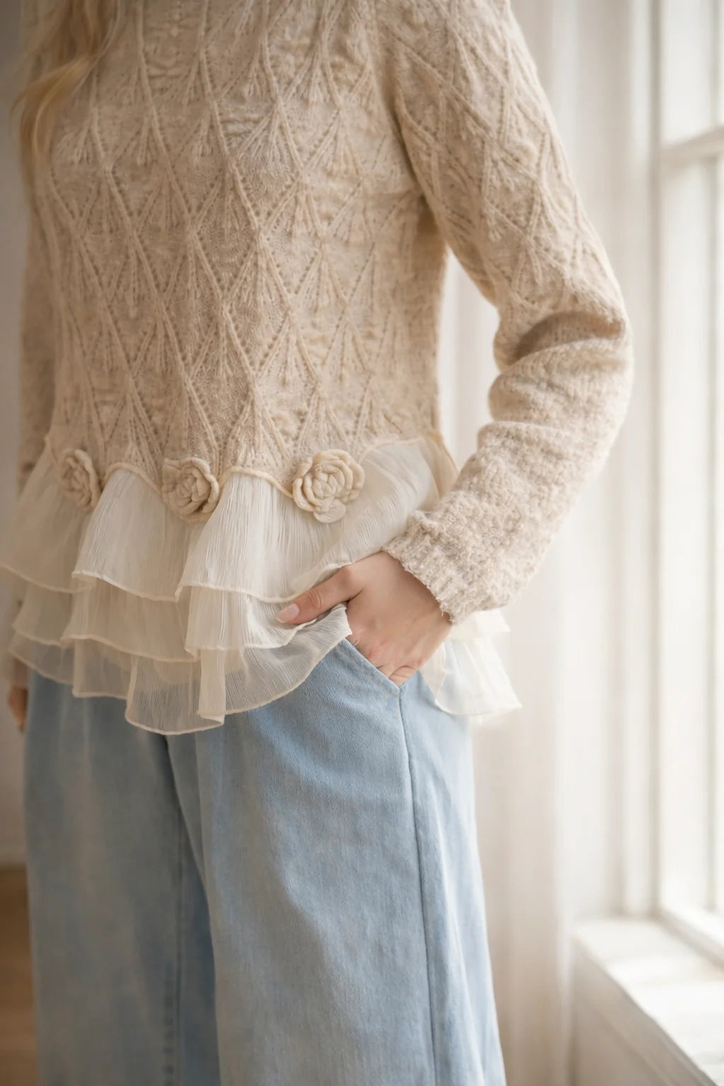 Close-up of the knit rosettes and layered sheer ruffles at the hem