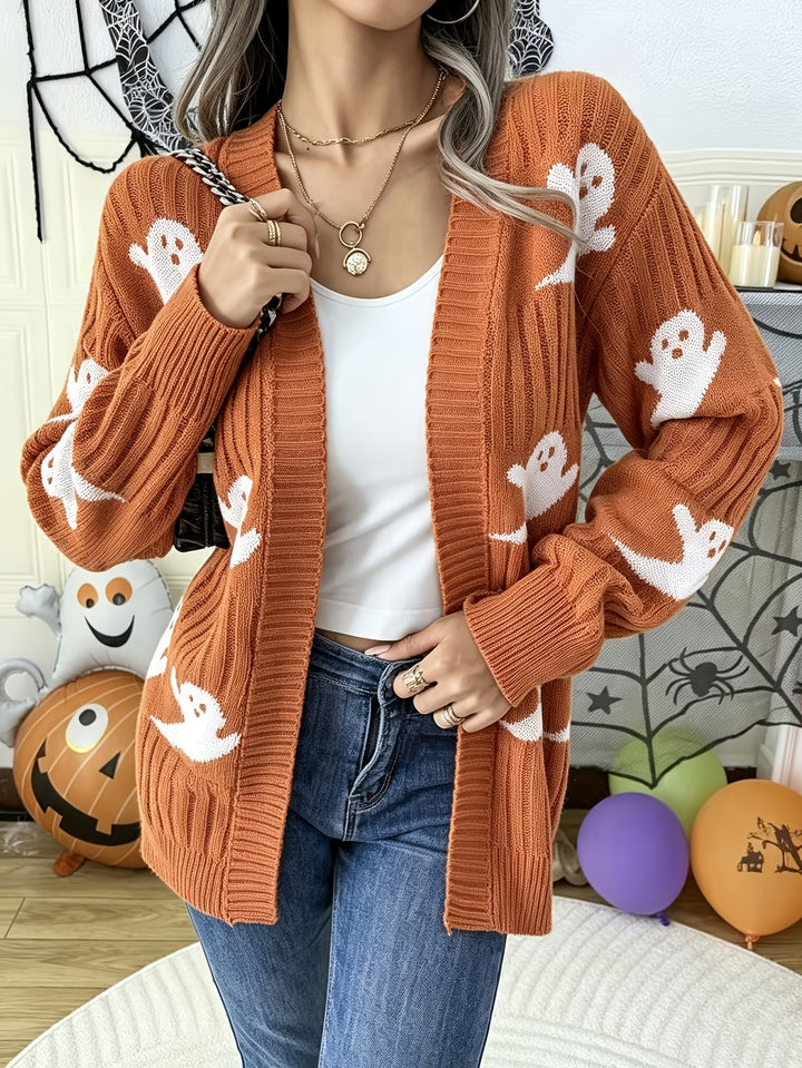 Rust orange loose knit cardigan with white ghost motifs, worn open over a white top