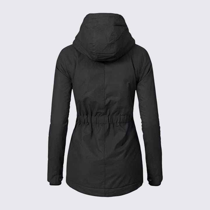 Back view of the black hooded parka, showing the elasticated waist and curved hem