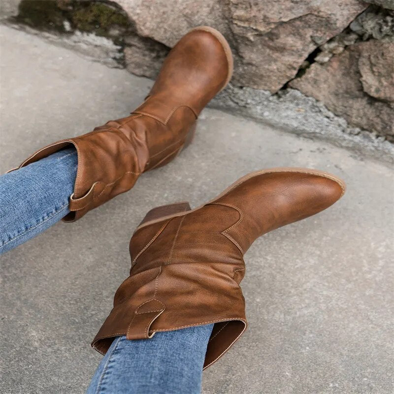 Camel slouch western boots worn with jeans, top view