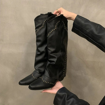 Black studded slouch knee boot held up to show the fold-over shaft