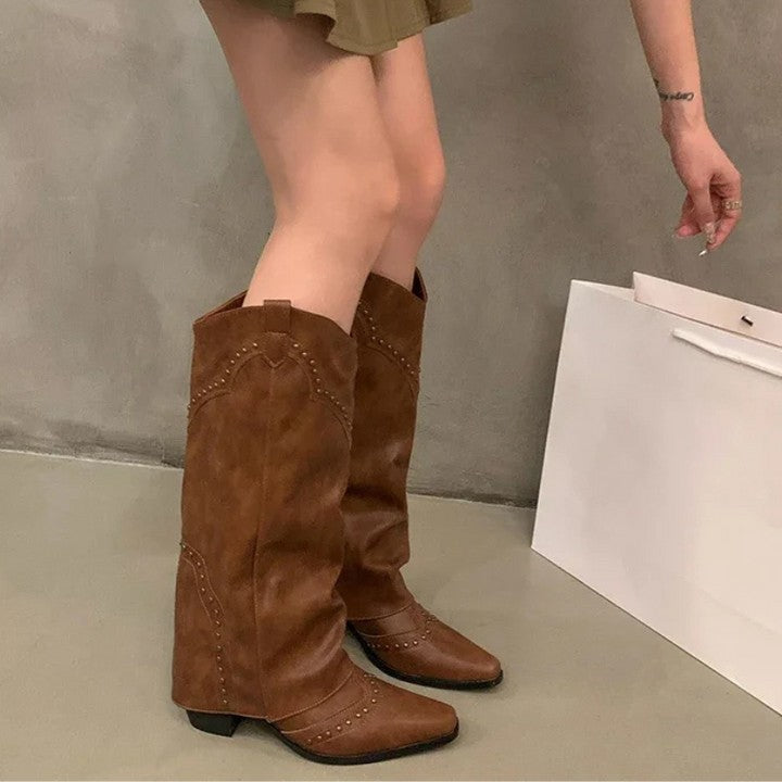 Tan studded slouch knee boots worn with a mini skirt