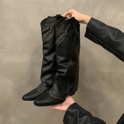 Black studded slouch knee boots held to show the stud trim