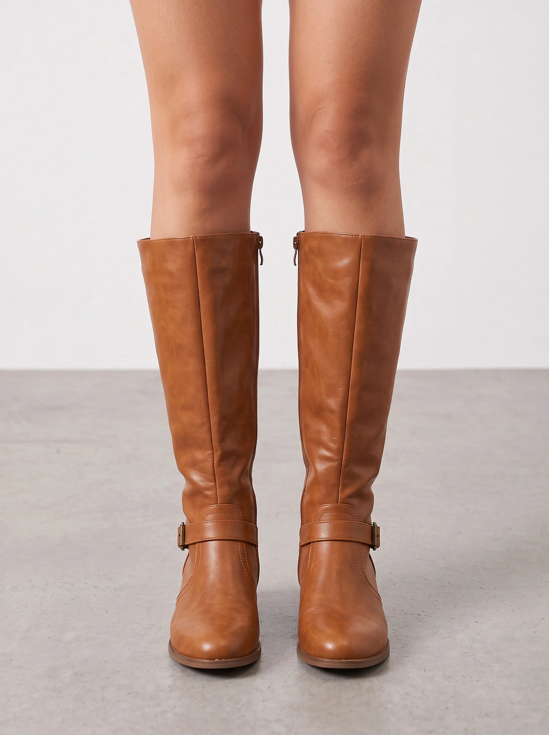 Tan leather riding boots with both ankle straps in view