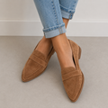 Tan suede pointed toe loafers worn with cropped jeans