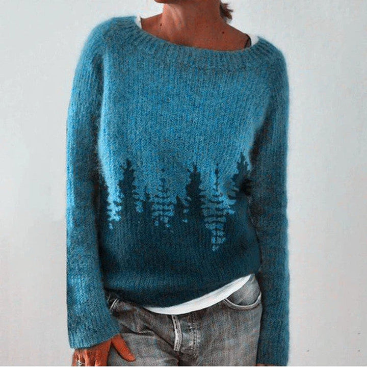 Teal knit pullover with a row of trees across the front