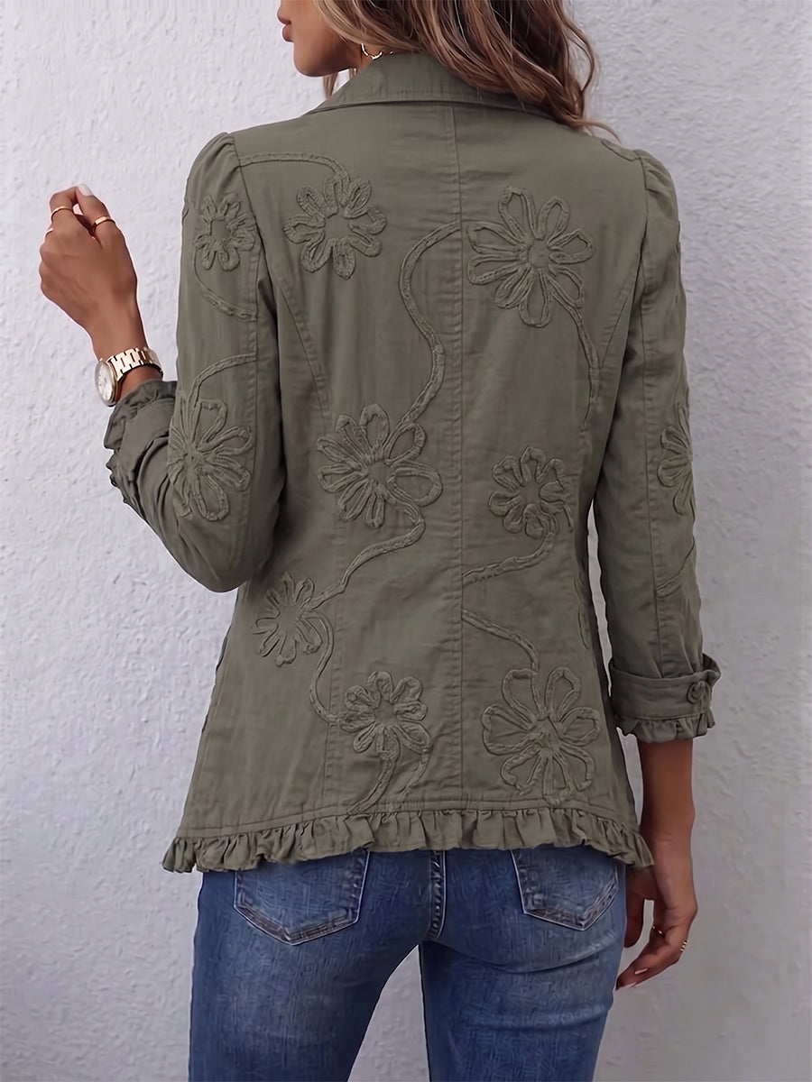 Olive jacket showing the embroidered back and ruffled hem, back view