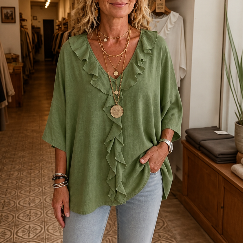 Sage green oversized blouse with ruffled V neck placket and half sleeves, front view