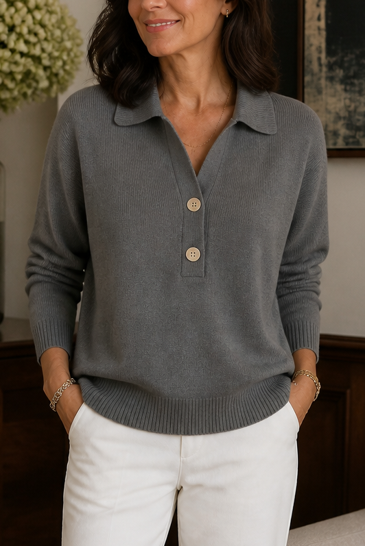 Grey knit sweater with a polo collar and two button placket, worn with white trousers, front view