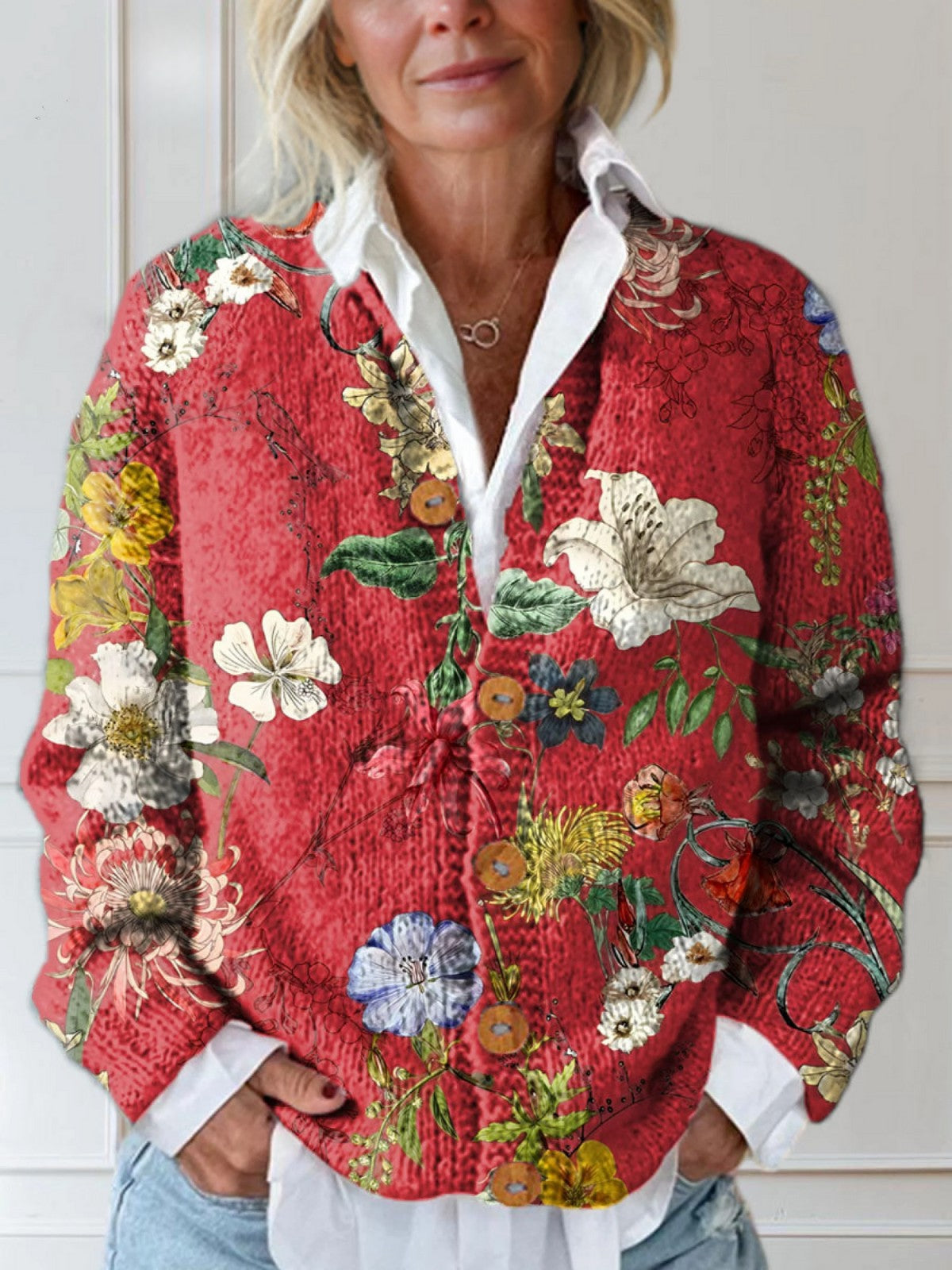 Red knit cardigan with a painted vintage floral print over a white shirt
