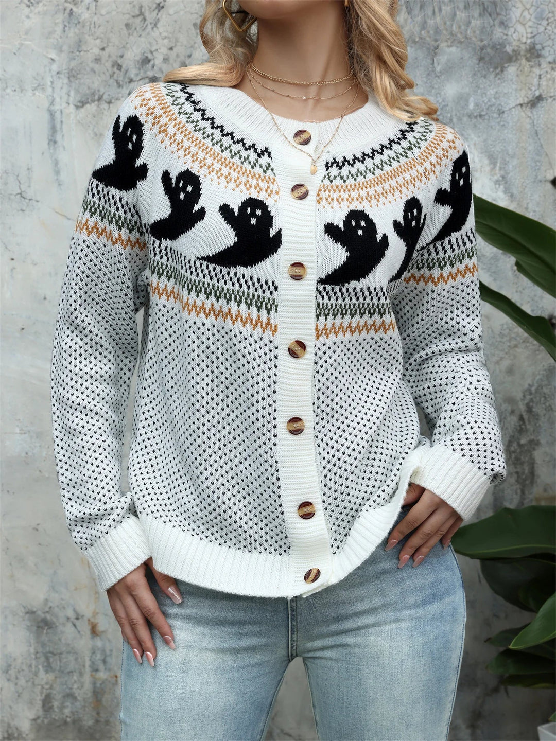 White knit cardigan with black ghost yoke pattern and wooden buttons, front view