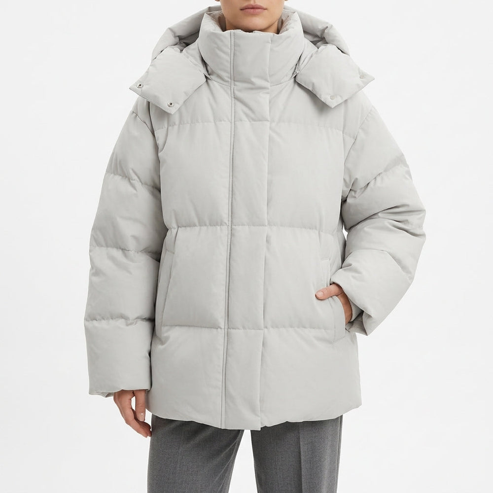 Pale grey oversized puffer coat with a wide hood, front view