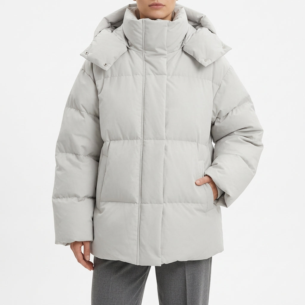 Pale grey oversized puffer coat with a wide hood, front view