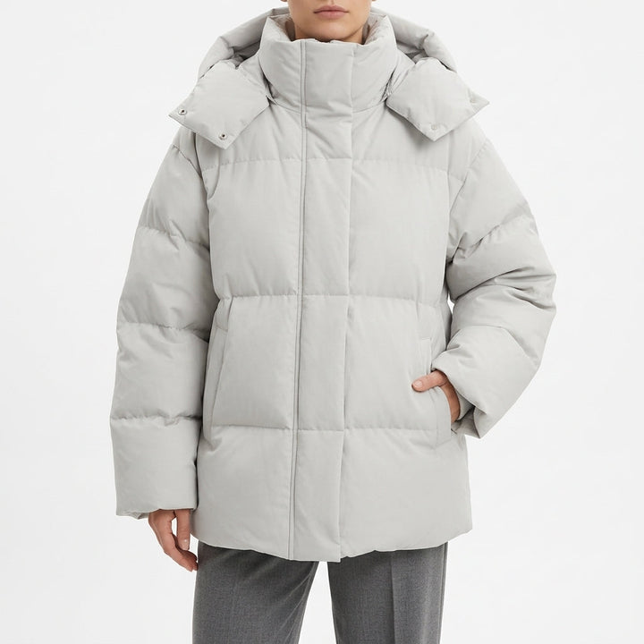 Pale grey oversized puffer coat with a wide hood, front view