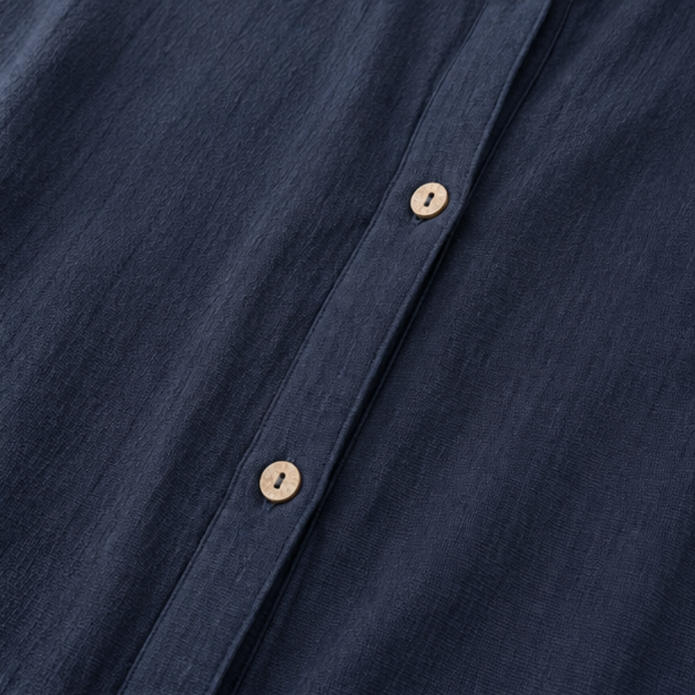 Wooden buttons down the front of a navy cotton jacket