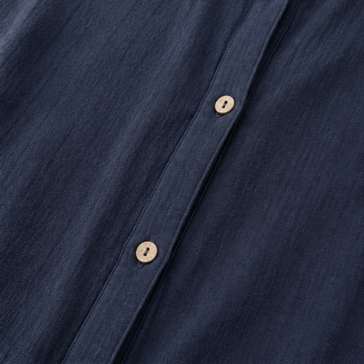 Wooden buttons down the front of a navy cotton jacket