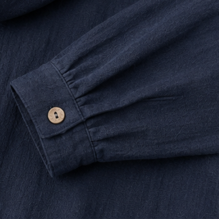 Buttoned cuff on a navy cotton hooded jacket sleeve
