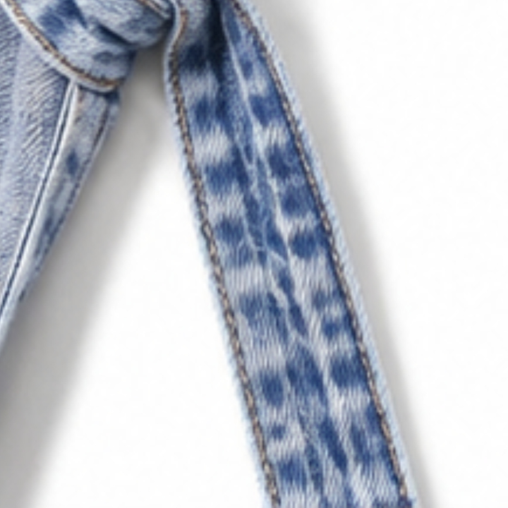 Knotted denim belt detail from a longline denim vest