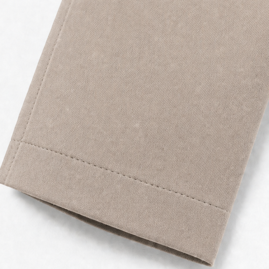 Stitched cuff detail on a taupe trench coat sleeve