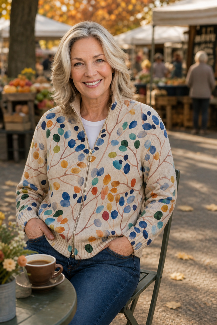 Woman with a coffee at a market in a botanical print bomber