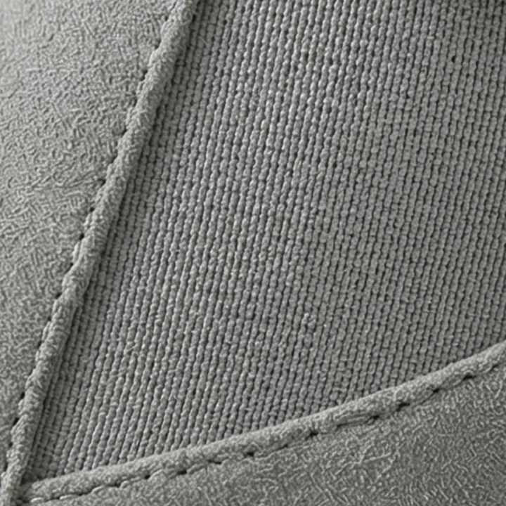 Silver buckle and elastic panel detail on a grey ankle bootie