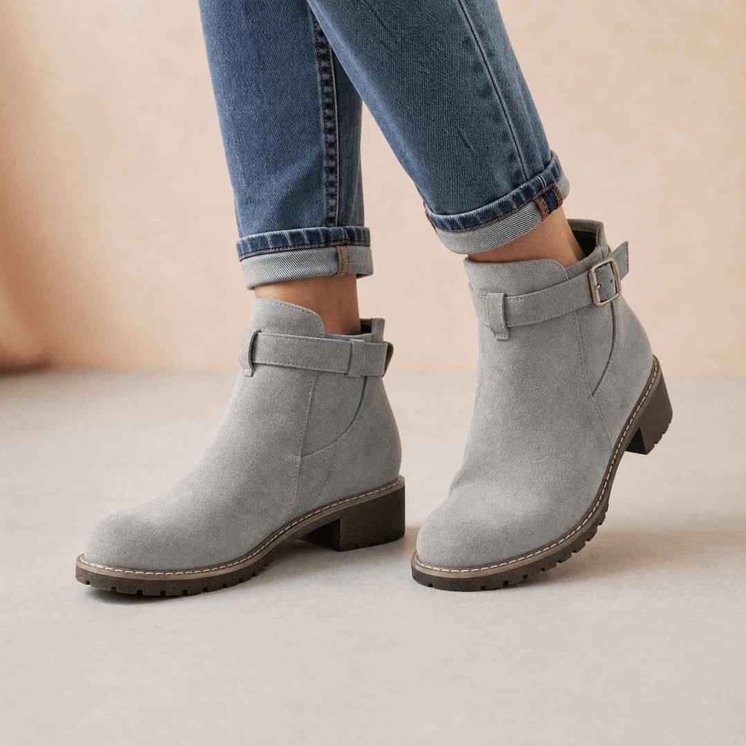 Grey suede ankle booties with buckle straps and elastic panels