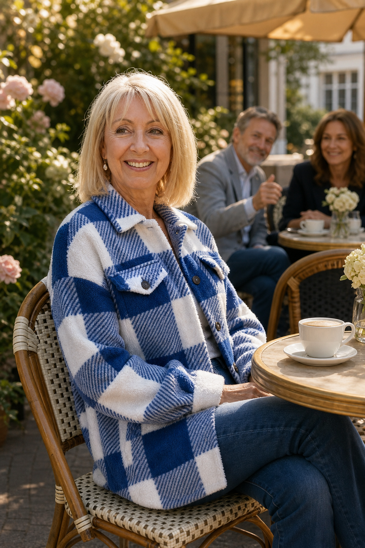 Woman at an outdoor cafe in a blue buffalo check sherpa overshirt